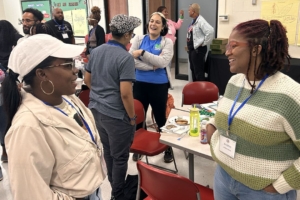 two women talking to each other, the woman on the right is smiling