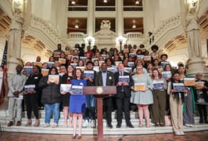 group of people standing on steps inside of PA capitol